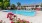 a swimming pool in a courtyard with lounge chairs